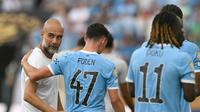 Manajer Manchester City asal Spanyol Pep Guardiola bereaksi dengan gelandang Inggris Phil Foden pada akhir pertandingan sepak bola Grup D Piala Dunia Antarklub 2025 antara Juventus Italia dan Manchester City Inggris di stadion Camping World di Orlando pada 26 Juni 2025. (PATRICIA DE MELO MOREIRA / AFP)