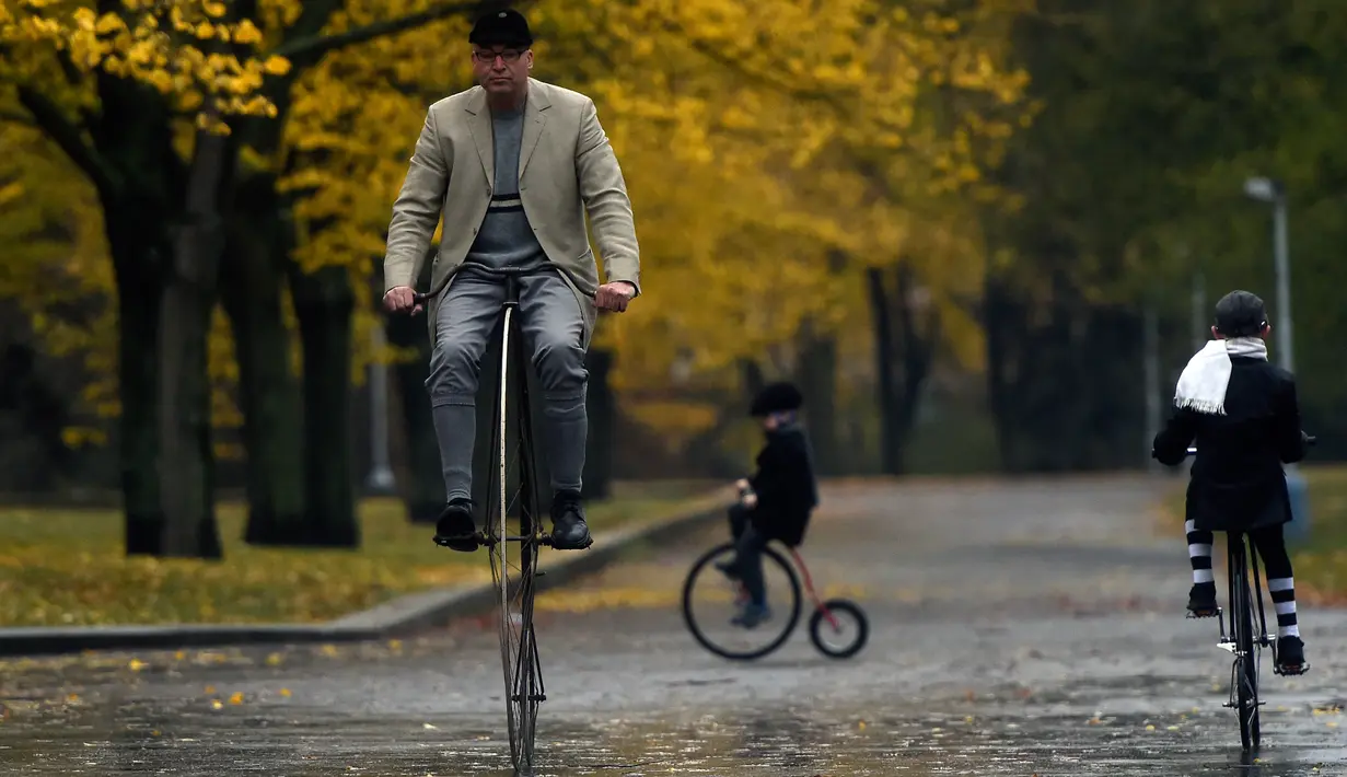Seorang penggemar sepeda mengenakan kostum sejarah sambil mengendarai Penny Farthing atau dikenal sebagai sepeda roda tinggi selama kompetisi tradisonal 'One Mile Race' di Praha, Republik Ceko pada 3 November 2018. (Photo by Michal CIZEK / AFP)