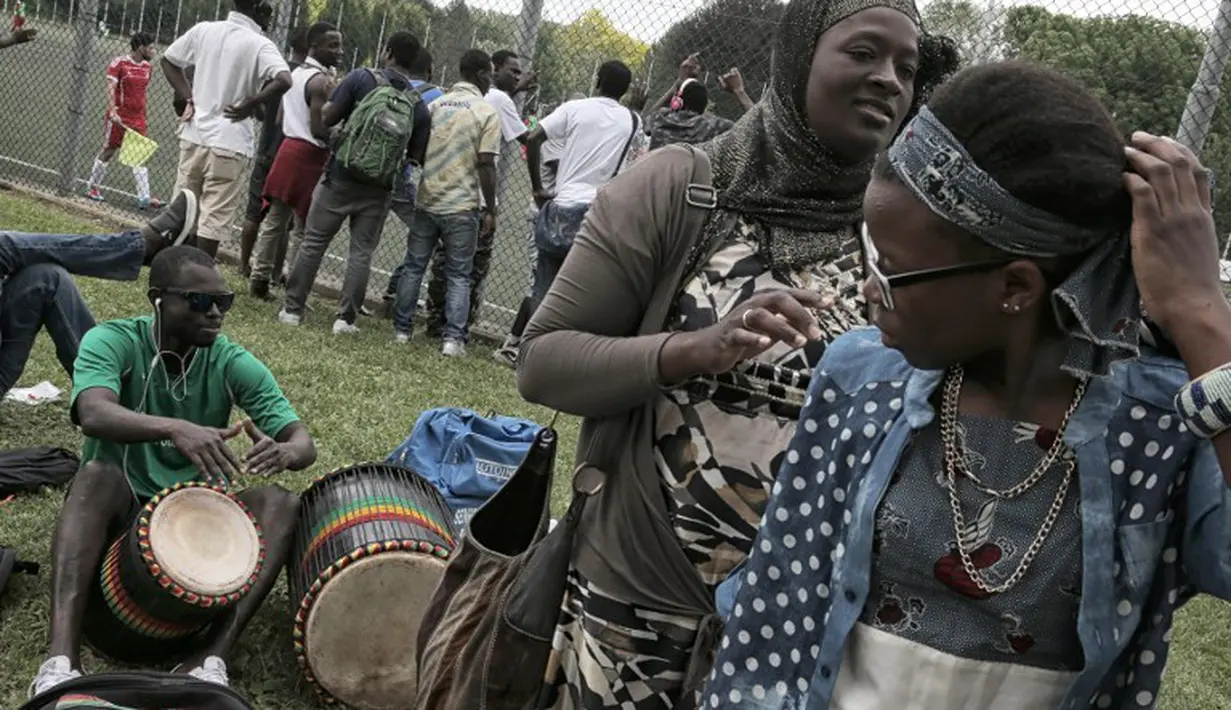 Suporter Mali  saat bertanding melawan Guinea dalam turnamen sepak bola untuk kaum migran dan orang asing bertajuk "Balon Mundial" yang dihelat 6 Juni-5 Juli 2015 di Turin, Italia. (AFP PHOTO/MARCO BERTORELLO)