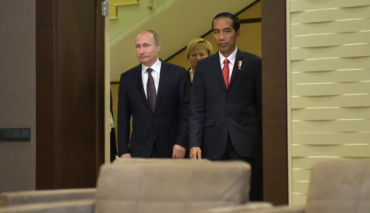 Presiden Rusia, Vladimir Putin (kanan) bersama Presiden RI, Jokowi berjalan ke aula untuk melakukan pertemuan di Sochi, Rusia, Rabu (18/5). Keduanya melakukan pertemuan bilateral sebelum KTT ASEAN-Rusia. (Alexei Druzhinin/Sputnik/Kremlin via Reuters)