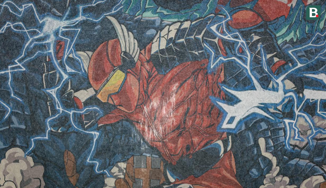 Gambar Gundala dalam koreografi raksasa dari suporter La Grande saat laga lanjutan putaran ketiga Grup C Kualifikasi Piala Dunia 2026 antara Timnas Indonesia melawan Jepang di Stadion Utama Gelora Bung Karno (SUGBK), Senayan, Jakarta, Jumat (15/11/2024). (Bola.com/Bagaskara Lazuardi)