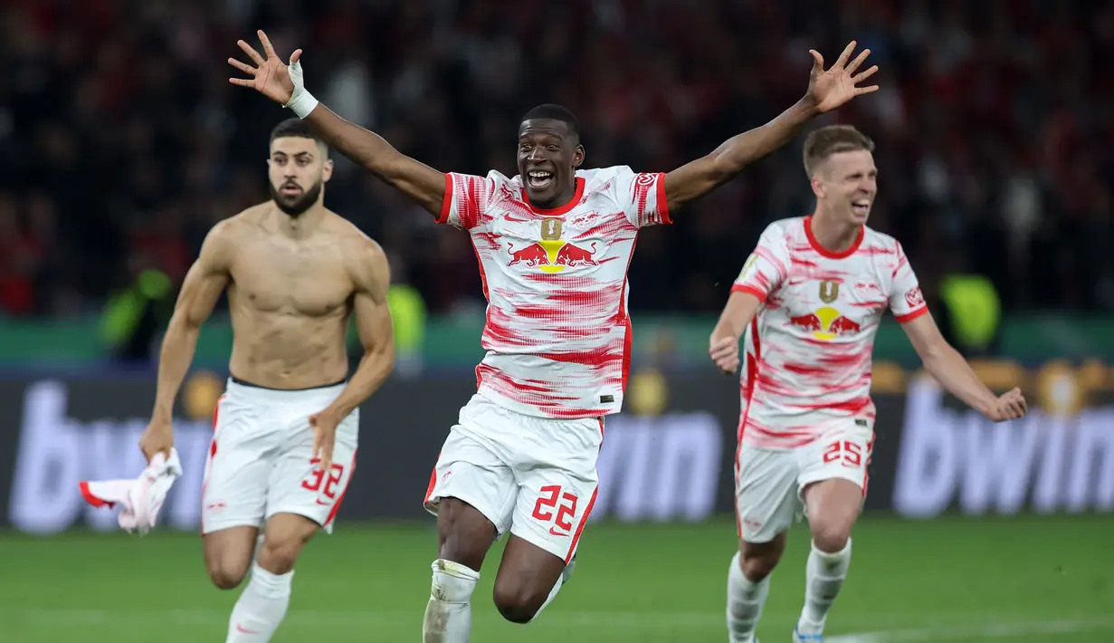 Pemain Leipzig, Nordi Mukiele (tengah) merayakan kemenangan bersama rekan setimnya usai mengalahkan SC Freiburg pada partai final DFB Pokal atau Piala Liga Jerman yang berlangsung di Stadion Olimpiade di Berlin, Jerman, Sabtu, 21 Mei 2022 waktu setempat. Die Bullen berhasil menang lewat babak adu penalti dengan skor 4-2 usai laga berjalan imbang 1-1. (AFP/Ronny Hartmann)