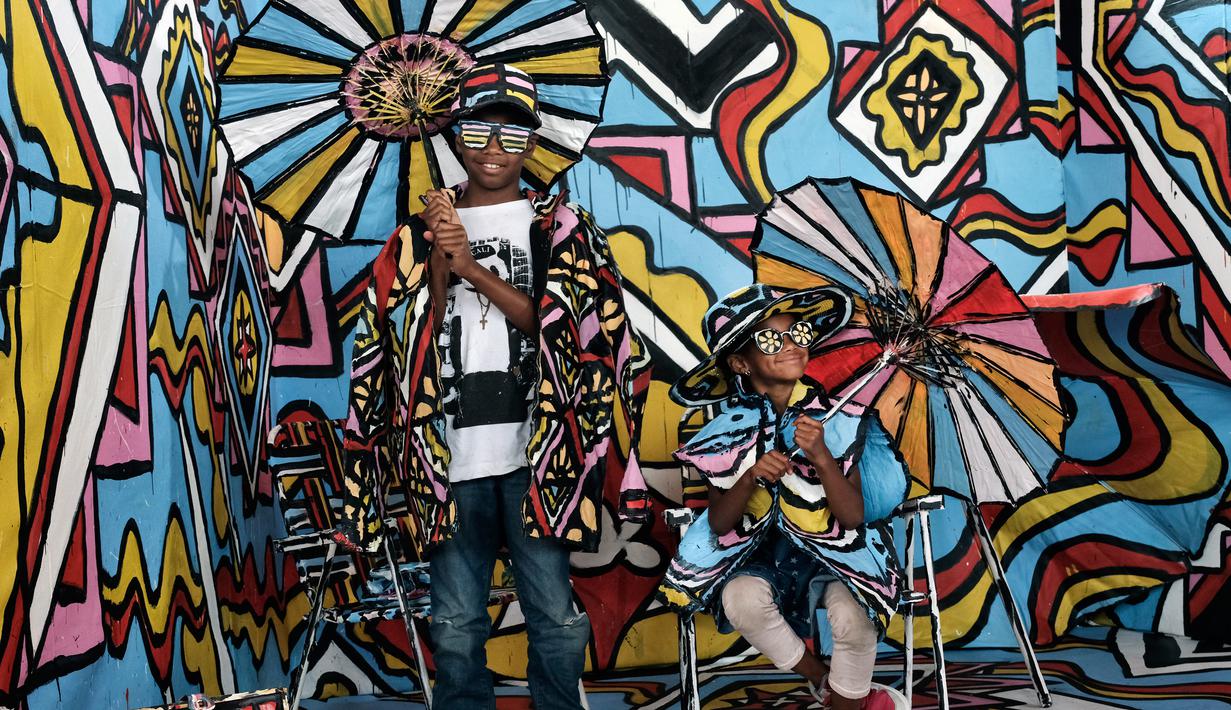 Myla Howard (kanan) berpose dengan saudaranya, Marcus dalam instalasi seni 3D interaktif di Union Station, Los Angeles, Kamis (7/6). Acara ini menampilkan budaya eklektik dengan instalasi seni interaktif gratis. (AP Photo/Richard Vogel)