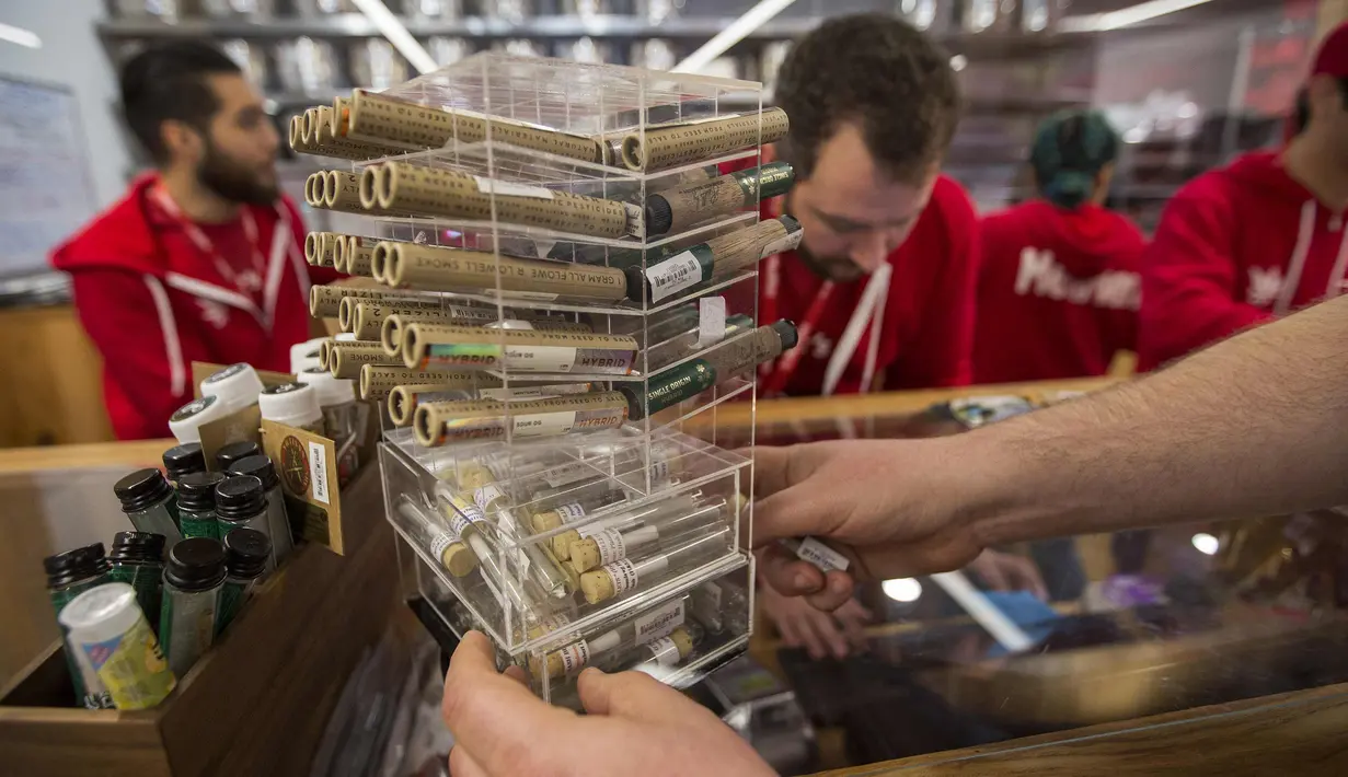 Pelanggan memilih produk ganja di MedMen, di West Hollywood, California (2/1). Los Angeles dan kota-kota terdekat lainnya di luar Hollywood Barat belum menyelesaikan perizinan lokal sehingga lisensi tersebut belum diberikan. (David McNew/AFP)