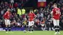 Pemain Manchester United Cristiano Ronaldo (kiri) dan Bruno Fernandes (tengah) bereaksi setelah pemain Liverpool Mohamed Salah mencetak gol ke gawang mereka pada pertandingan Liga Inggris di Old Trafford, Manchester, Inggris, Minggu (24/10/2021). Liverpool menang 5-0. (AP Photo/Rui Vieira)