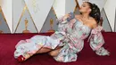 Pose rebahan penyanyi Andra Day di karpet merah saat menghadiri penghargaan Piala Oscars 2018 di Dolby Theatre, Los Angeles, Minggu (4/3). Pose Andra Day ini menjadi momen unik dalam sejarah Academy Awards yang memasuki tahun ke-90. (VALERIE MACON / AFP)