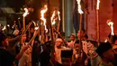 Sejumlah anak-anak mengambil bagian dalam pawai obor pada malam Idul Fitri 1446 Hijriah, yang menandai berakhirnya bulan puasa Ramadan, di Surabaya pada 30 Maret 2025. (JUNI KRISWANTO/AFP)