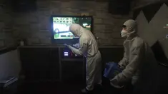 Petugas mengenakan pakaian pelindung menyemprotkan Disinfektan untuk mencegah penyebaran virus corona Covid-19 di Karaoke di Seoul, Korea Selatan, (13/3/2020). Penyemprotan disinfektan terus dilakukan di setiap sudut tempat di Korsel. Salah satunya sampai ke tempat karaoke. (AP Photo/Ahn Young-joon)