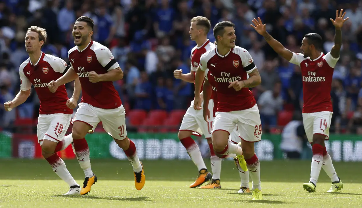 Para pemain Arsenal berlari merayakan gelar Community Shield usai mengalahkan Chelsea di Stadion Wembley, London, Minggu (6/8/2017). Ini merupakan trofi Community Shield yang ke-15 bagi Arsenal. (AFP/Ian Kington)