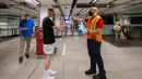 Seorang staf Toronto Transit Commission (TTC) membagikan masker baru kepada penumpang di stasiun kereta bawah tanah di Toronto, Kanada, pada 2 Juli 2020. TTC mewajibkan para pengguna layanan kereta memakai masker atau penutup wajah mulai Kamis (2/7) karena pandemi COVID-19. (Xinhua/Zou Zheng)