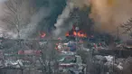 Asap mengepul dari kebakaran di permukiman kumuh desa Guryong, pemukiman informal terbesar di Seoul, Korea Selatan, pada Jumat 16 Januari 2026. Kebakaran besar melanda kawasan permukiman kumuh, Guryong Village di Distrik Gangnam, Seoul, Korea Selatan. (YONHAP/AFP)