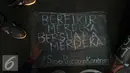 Aktivis meletakkan tulisan saat aksi kamisan di depan Istana Merdeka, Jakarta, Kamis (4/8). Aksi ini juga memberi dukungan buat Koordinator Kontras Haris Azhar yang dituduh melakukan pencemaran nama baik sejumlah lembaga. (Liputan6.com/Helmi Fithriansyah)