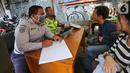 Petugas memberi peringatan kepada pengendara bermotor karena tidak menggunakan masker dan helm pada pada hari pertama PSBB di jalur check point Jalan Ir. H Juanda, Ciputat, Tangerang Selatan, Sabtu (18/4/2020). Selama PSBB pengendara wajib kenakan masker. (Liputan6.com/Fery Pradolo)