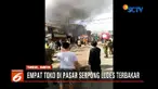 Api dengan cepat membesar dan merambat dari satu toko ke toko lainnya.