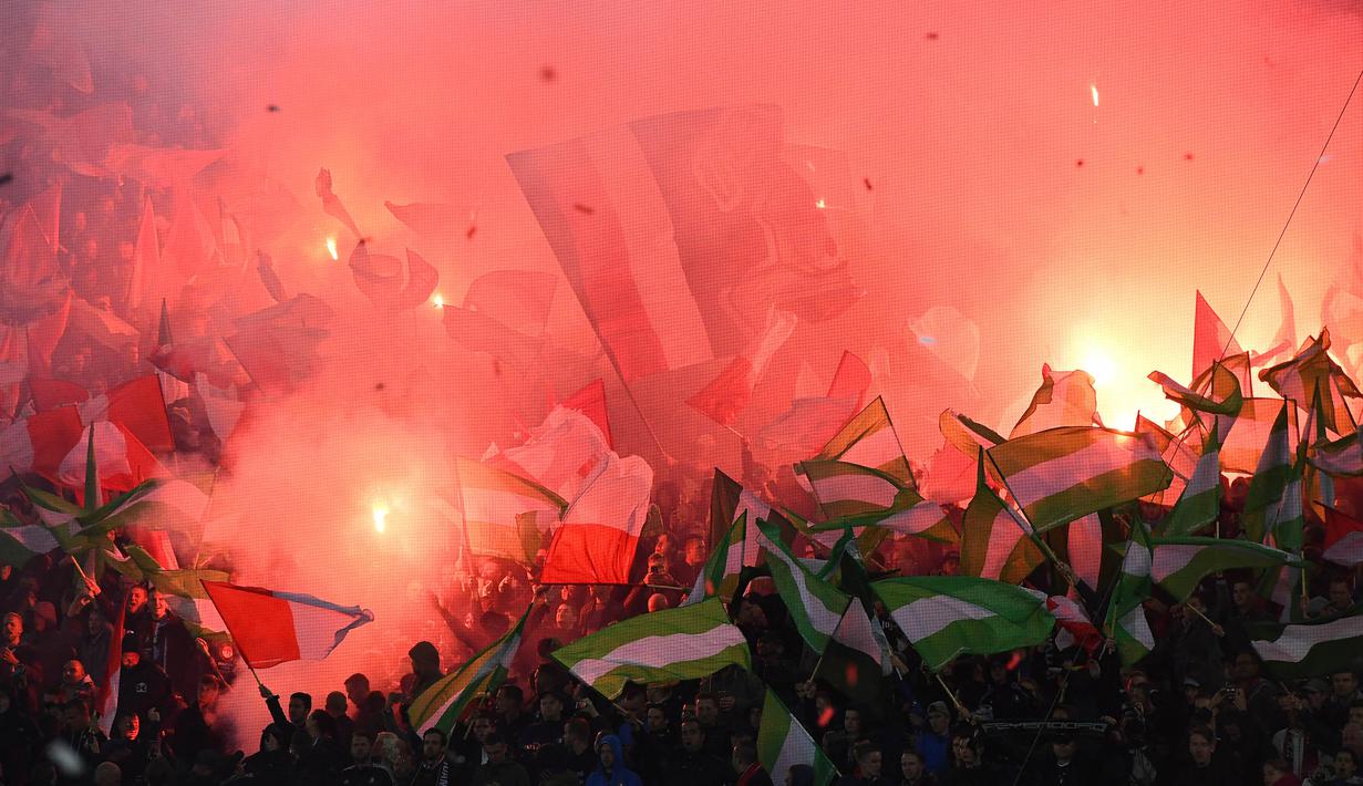 7. Suporter Feyenoord merayakan kembalinya klub asal Rotterdam itu ke Liga Champions dengan menyalakan flare. Sayangnya pada pertandingan tersebut mereka menelan kalah telak 0-5 dari wakil Inggris, Manchester City. (AFP/Emmanuel Dunand)