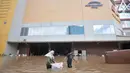 Aktivitas pedagang mengevakuasi barang-barang saat banjir merendam Mall Cipinang Indah, Jakarta Timur, Rabu (1/1/2020). Selain merendam permukiman warga, banjir kali ini juga melumpuhkan Mal Cipinang Indah yang terpaksa ditutup akibat terendam air. (merdeka.com/Iqbal S Nugroho)