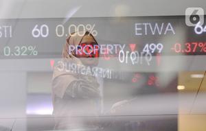 Pengunjung melintas dilayar pergerakan saham di BEI, Jakarta, Senin (30/12/2019). Pada penutupan IHSG 2019 ditutup melemah cukup signifikan 29,78 (0,47%) ke posisi 6.194.50. (Liputan6.com/Angga Yuniar)