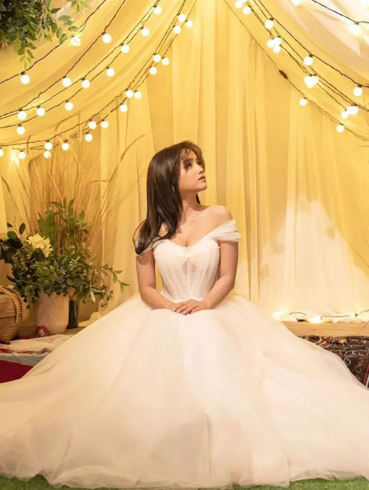 Dengan detail gaun atasan model bustier dan rok panjang flowy menyapu lantai. Membuatnya tampil elegan memesona bak princess.  [@fuji_an]