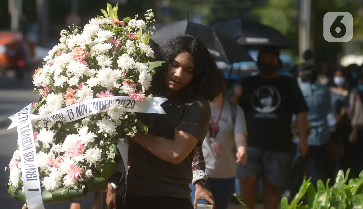 Aktivis melakukan aksi damai membawa karangan bunga saat memperingati 22 tahun Tragedi Semanggi I di Gedung Kejaksaan Agung RI, Jakarta, Jumat (13/11/2020). (merdeka.com/Imam Buhori)