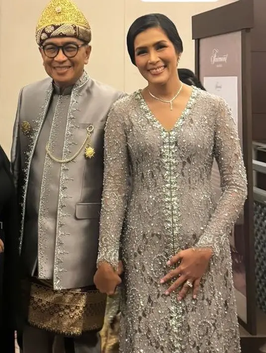 Saat resepsi, Helmy Yahya dan istri masih mengenakan busana warna abu-abu. Kali ini Helmy mengenakan beskap dengan inner dan sarung setengah di atas celana panjangnya. [@erniaredberry]