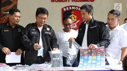 Petugas menunjukkan barang bukti pembobol uang dari mesin ATM dengan teknik skimming diperlihatkan petugas Resmob Polda Metro Jaya saat rilis di Jakarta, Sabtu (17/3). Kasus melibatkan empat WNA dan seorang WNI. (Liputan6.com/Helmi Fithriansyah)