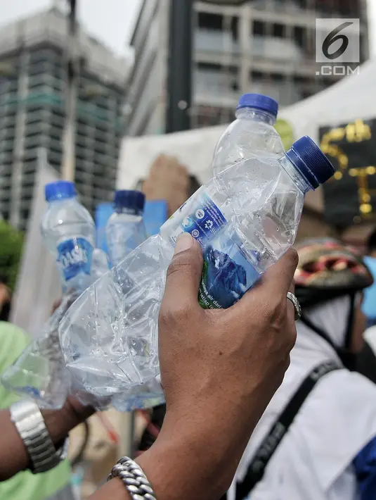 Warga membawa botol bekas untuk ditukarkan dengan hadiah di stan ENVIRUN selama hari bebas kendaraan atau car free day (CFD) di Jakarta, Minggu (8/4). (Merdeka.com/Iqbal Nugroho)