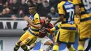 Aksi Hakan Calhanoglu saat melewati pemain Parma dalam laga lanjutan giornata ke-14 Serie A yang berlangsung di stadion San Siro, Milan, Minggu (2/12). AC Milan menang 2-1. (AFP/Miguel Medina)