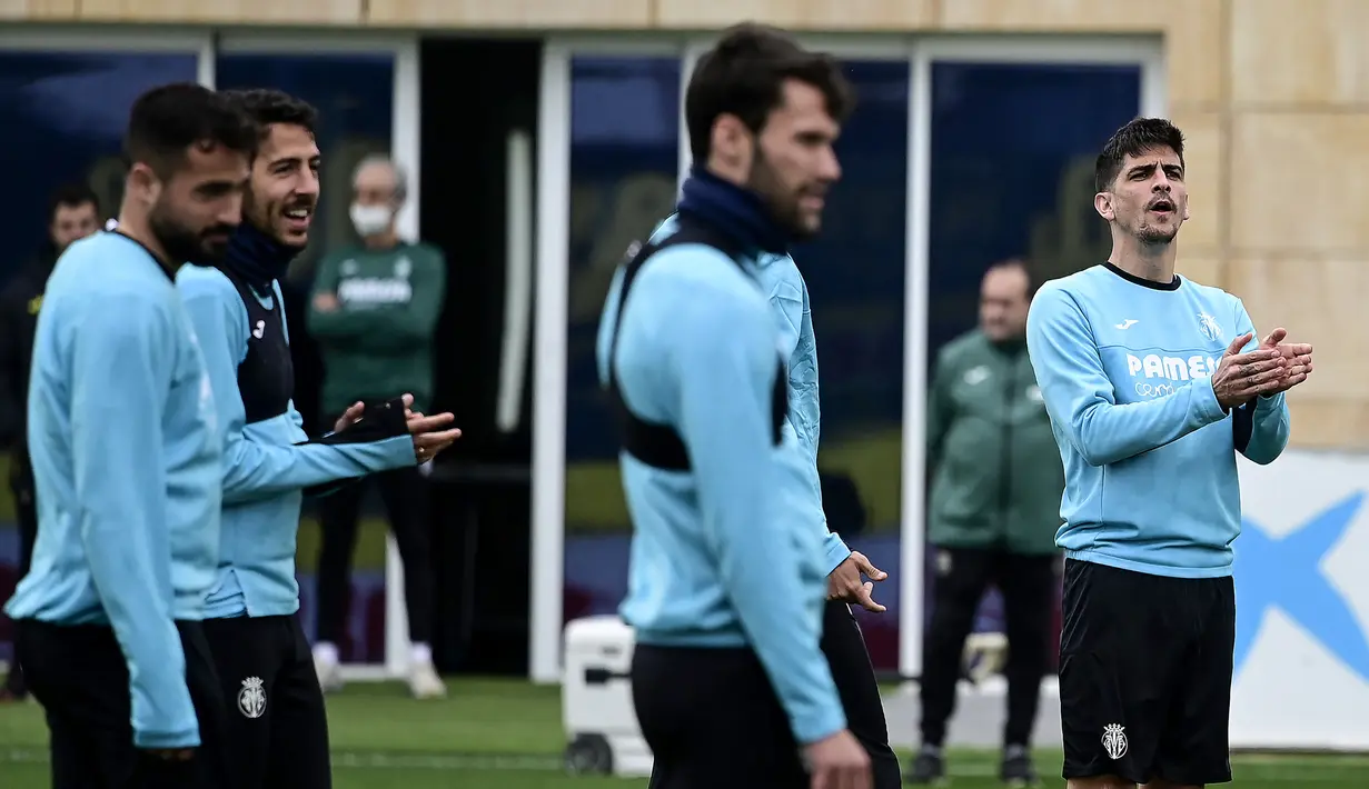 Penyerang Villarreal Gerard Moreno (kanan) bertepuk tangan saat mengambil bagian dalam sesi latihan di Ciudad deportiva Villarreal di Vila-Real, Selasa (15/3/2022). Villarreal akan berhadapan dengan Juventus dalam leg kedua babak 16 besar Liga Champions pada Rabu, 16 Maret 2022 (JOSE JORDAN/STR/AFP)