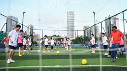 Xu Yongzhong, guru di Sekolah Menengah No.10 Guangzhou, memberikan instruksi kepada siswa di lapangan olahraga di atas gedung Sekolah Menengah No.10 Guangzhou di Guangzhou, Provinsi Guangdong, China selatan (17/9/2020). (Xinhua/Deng Hua)