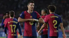 Striker Barcelona, Robert Lewandowski, merayakan gol yang ia cetak ke gawang Getafe pada lanjutan Liga Spanyol 2024/2025, Kamis (26/9/2024) dini hari WIB. (LLUIS GENE / AFP)