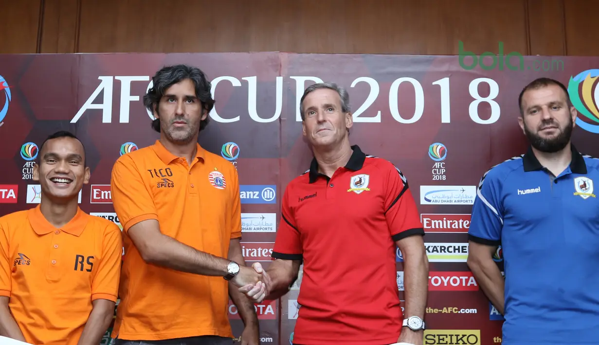 Pelatih Tampines Rovers, Juergen Raab (2kanan) bersalaman dengan pelatih Persija, Stefano Teco saat konferensi pers Piala AFC 2018 di Hotel Sultan, Jakarta (27/2/2018). Persija akan menjamu Tampines Rovers pada 28 Februari 2018. (Bola.com/Nick Hanoatubun)