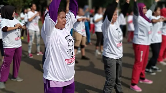 Masyarakat yang mendukung Presiden Jokowi menggelar senam di car free day (CFD), Jakarta