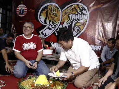 Direktur Utama Persija Jakarta, Gede Widiade, didampingi Ketua Umum Jakmania, Ferry Indrasjarief, memotong tumpeng saat acara syukuran di Kantor Persija, Jakarta. Acara ini merupakan peringatan hari jadi Persija ke-90. (Bola.com/Yoppy Renato)