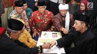 Gubernur DKI Jakarta, Anies Baswedan dan Abdullah Gymnastiar menjadi saksi pernikahan pasangan tertua dalam nikah massal dan isbat nikah pada malam pergantian tahun 2018-2019 di Jakarta, Senin (31/12). Liputan6.com/Helmi Fithriansyah)
