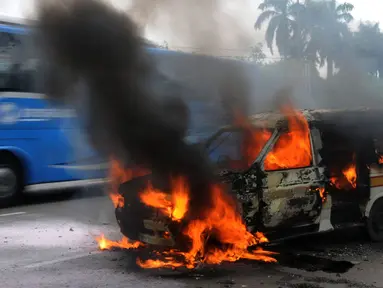 Satu unit angkutan kota (angkot) C062 jurusan Ciledug-Cipete terbakar di kawasan Kebun Nanas, Tangerang, Kamis (17/5). Kebakaran diduga terjadi akibat hubungan arus pendek kabel aki dan tidak ada korban jiwa dalam peristiwa itu. (Merdeka.com/Arie Basuki)