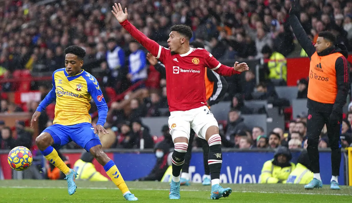 Pemain Manchester United Jadon Sancho (tengah) mengajukan protes saat pemain Southampton Kyle Walker-Peters mendekati bola pada pertandingan sepak bola Liga Inggris di Stadion Old Trafford, Manchester, Inggris, 12 Februari 2022. Pertandingan berakhir dengan skor 1-1. (AP Photo/Jon Super)