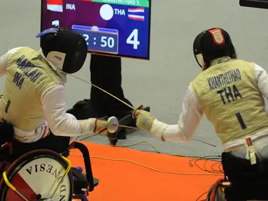 Atlet anggar kursi roda Indonesia, Radilah Hendri beradu jurus dengan Khanthithao (Thailand) pada babak perempat final Beregu Senior Putra Asian Para Games 2018 di Cibubur, Jakarta, Senin (8/10). Indonesia gagal ke semifinal. (Merdeka.com/Arie Basuki)