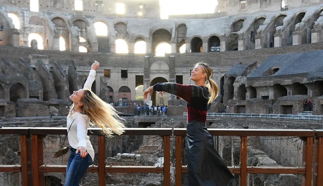 Maria Sharapova menari bersama asistennya di Colosseum, Roma, Minggu (14/5/2017).  (AFP/Vincenzo PInto).