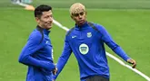 Pemain Barcelona, Lamine Yamal (kanan) dan Robert Lewandowski tampak dalam latihan menjelang laga leg 2 semifinal Liga Champions 2024/2025 melawan Inter Milan di Giuseppe Meazza, Milan, Italia. (AFP/Piero Cruciatti)