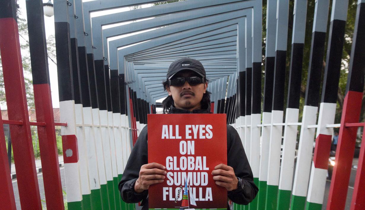 Seorang aktivis berpose saat aksi solidaritas menentang pencegatan kapal-kapal yang berpartisipasi dalam armada Global Sumud Flotilla, sebuah misi bantuan kemanusiaan warga sipil ke Gaza melalui laut, di Bandung, Jawa Barat, pada Selasa 19 Mei 2026. (Timur Matahari/AFP)