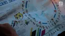 Surat kabar Malaysia, Metro Ahad, menampilkan infografis terkait 11 negara peserta SEA Games 2017 di Kuala Lumpur, Minggu (20/8). Di artikel berjudul 'Mencari Jagoan', bendera Indonesia tercetak putih-merah, bukan merah-putih. (Liputan6.com/Faizal Fanani)