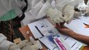Paramedis mengambil sampel penumpang KRL Commuter Line saat tes swab di Stasiun Bojonggeder, Jawa Barat, Senin (11/05/2020).  Pemkab Bogor  melakukan tes swab  dan rapid test bagi penumpang KRL Commuter Line  dilakukan secara massal. (merdeka.com/Arie Basuki)