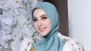 Dress tersebut dipadukan dengan kerudung warna hijau. Tak lupa ia membawa clutch warna hijau dari Hermes. [@princessyahrini]