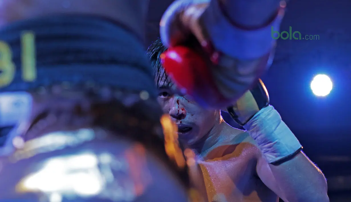 Darah mengucur dari hidung petinju Thailand, Phuttiphong Rakoon saat melawan Jansen Marapu pada laga Mahkota Boxing Super Series di Cilandak Town Square, Jakarta (10/3/2018). Jansen menang TKO pada ronde ke sembilan. (Bola.com/Nick Hanoatubun)