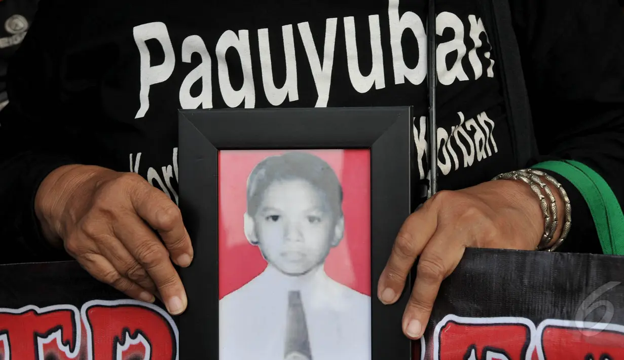 Salah satu foto korban pelanggaran Ham dibawa saat aksi Kamisan di depan Istana Negara, Jakarta, Kamis (21/5/2015). Kontras menilai pemerintah telah gagal memberikan kepastian hukum. (Liputan6.com/Johan Tallo)