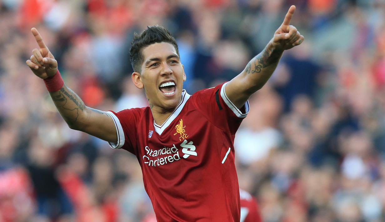 Pemain Liverpool, Roberto Firmino merayakan golnya ke gawang AFC Bournemouth pada lanjutan Premier League di Anfield stadium, Liverpool,(14/4/2018). Liverpool menang 3-0.  (AFP/Lindsey Parnaby)