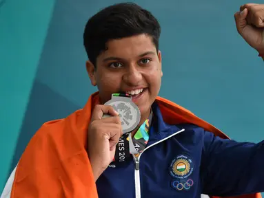 Penembak India, Vihan Shardul (15) berpose dengan medali perak usai menerima penghargaan di nomor double trap putra Asian Games 2018 di Palembang, Kamis (23/8). Shardul Vihan menjadi penembak terbaik kedua dengan catatan skor 73. (AFP/ADEK BERRY)