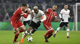 Gelandang Besiktas, Talisca, berusaha melewati kepungan pemain Bayern Munchen pada laga Liga Champions di Stadion Allianz Arena, Munchen, Selasa (20/2/2018). Munchen menang 5-0 atas Besiktas. (AFP/Thomas Kienzle)