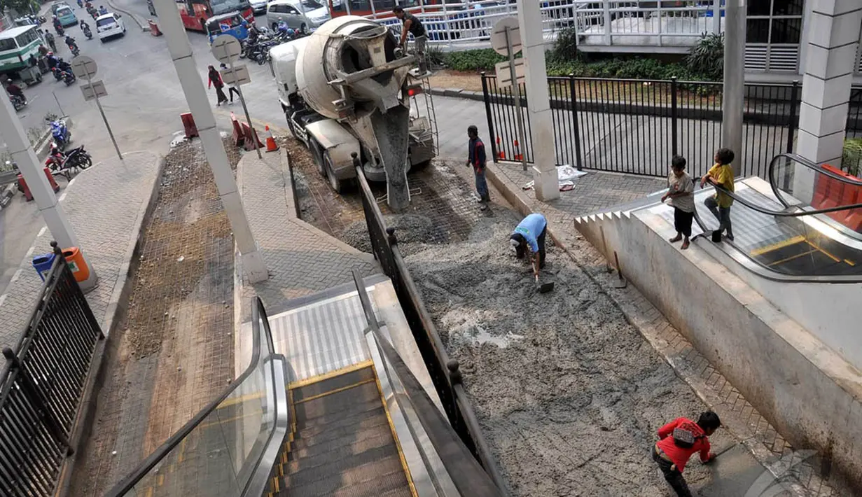 Para pekerja mengecor jalur yang ada di Terminal Manggarai, Jakarta, Minggu (28/8/2014) (Liputan6.com/Miftahul Hayat)