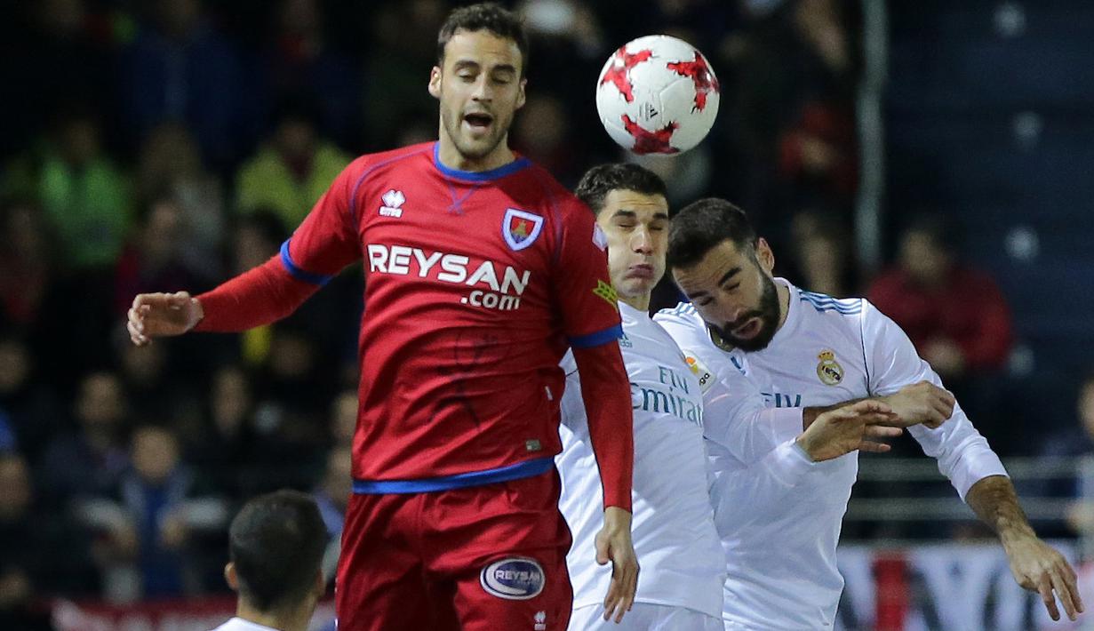 Duel pemain Numancia, Pere Milla (kiri) dengan pemain Real Madrid pada laga Copa Del Rey di Nuevo Estadio Los Pajaritos stadium, Soria, (4/1/2018). Madrid menang 3-0. (AFP/Cesar Manso)